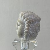 A small possibly 15th or 16th century carved marble figural bust depicting Janus the Roman god of