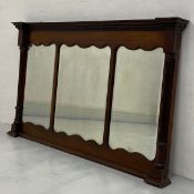 A C.1900 mahogany overmantel mirror with triple shaped plates flanked by pilasters. H.78.5 W.131cm