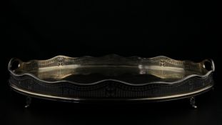 A late 19th century hallmarked silver serving tray having an engraved oval top with an openwork