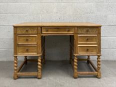 A mid 20th century oak partner's desk having a rectangular thumb moulded plank top over an
