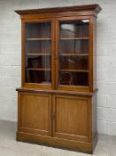 A 19th century mahogany library bookcase having a moulded cornice over two glazed doors opening on