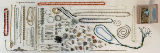 A large mixed collection of jewellery to include necklaces, bracelets, bangles, brooches, pins and