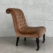 A 19th century slipper chair having a scrolled button back and stuffover seat upholstered in pink