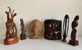 Six wood carvings to include three abstract modernist hardwood figure groups, a Balinese bust of a