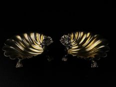 A pair of 18th century hallmarked silver three footed clam shell dishes with gilt interiors by