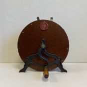 A C.1900 Spong & Co. oak and cast iron knife sharpener with a cast and cold painted faux wax seal