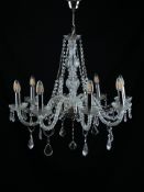 A vintage Venetian style chandelier having eight scrolling branches extending from a central