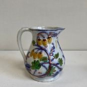 A collection of six 19th century hand painted Gaudy Welsh and other porcelain jugs to include an