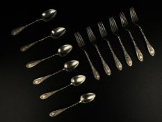 A set of twelve Greek white metal teaspoons and forks each having a twisted stem with a scrolling