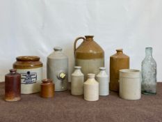 A mixed collection of C.1900 stoneware flagons, bottles and other vessels. H.31cm