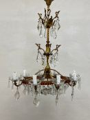 A 20th century Continental gilt metal chandelier having a central stem with three tiers of scrolling