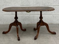 a Georgian style walnut low side table in two parts having an oval book matched and crossbanded