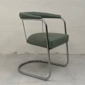 A mid century tubular chrome armchair having a cushioned back and arms over a vinyl upholstered
