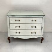 An Art Deco style mirrored chest of drawers having a rectangular top above three long drawers with