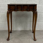 A 19th century mahogany side table having a rectangular crossbanded top with lobed corners over four