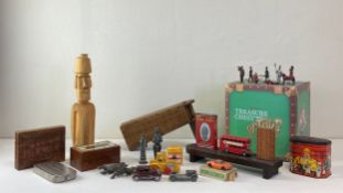 A mixed collection of toys to include three cribbage games, a carved wood Easter Island head, a