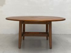 A large 20th century painted and distressed pine dining table having a circular thumb moulded top
