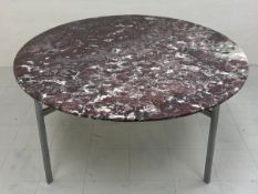 A large contemporary dining table having a circular marble top raised on square steel supports