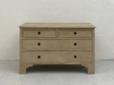 A 20th century painted pine chest of drawers having a rectangular thumb moulded top above two