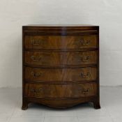 A Georgian style mahogany bow fronted bachelors chest having a book matched and crossbanded top with