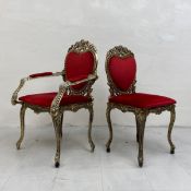 A pair of gilt metal vintage Baroque style his and hers chairs each having a scrolling openwork