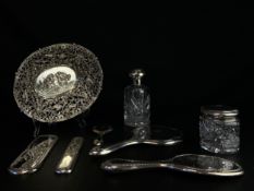 A collection of hallmarked silver to include a vanity set with an engraved crest comprised of