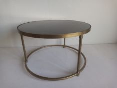 A vintage style low side table having a circular perspex top set into a gilt metal frame. Dia.49 H.