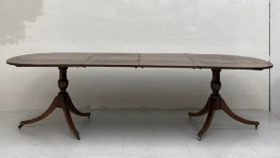 A Georgian style mahogany extending d-end dining table having a book matched and crossbanded oval