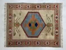 A hand knotted Turkish wool Konya carpet having an abstract hexagonal central lozenge medallion in