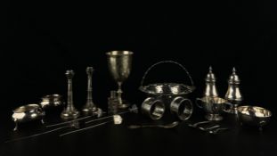 A mixed collection of hallmarked silver and white metal to include a pair of candlesticks, napkin