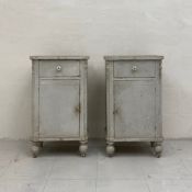 A pair of late 19th century painted pine bedside cupboards each having a square top with a single