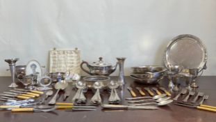 A large mixed collection of silver plate to include cutlery, dishes, trays, a teapot and other items
