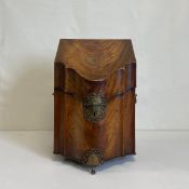A Georgian mahogany knife box having a sloped serpentine and break-front lid with a featherbanded