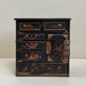 An 19th century Japanese Meiji period copper mounted black lacquered tabletop cabinet having a