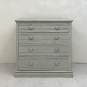A C.1900 painted pine chest of drawers having a rectangular moulded top above an arrangement of