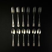 A set of twelve white metal cake forks and tea spoons with lion passant crested handles and