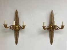 A pair of French Empire style brass wall sconces each having an openwork acanthus leaf plate with