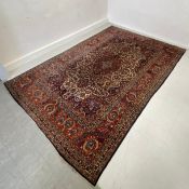 A large 20th century hand knotted Kashan carpet having a central lozenge medallion surrounded by