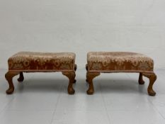 A pair of 19th century walnut footstools each having a stuff-over tapestry top raised on four