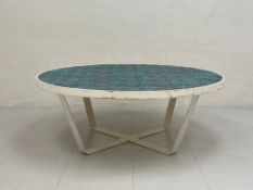 A vintage coffee table by Mambo Unlimited Ideas having a circular tiled top in graduating shades