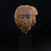 An Indian possibly Gupta period sculpted terracotta figural bust or head raised on a museum style