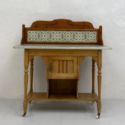 A C.1900 ash washstand having a shaped and tiled gallery back on a rectangular white marble top over