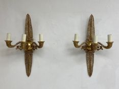 A pair of French Empire style brass wall sconces each having an openwork acanthus leaf plate with