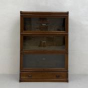 An early 20th century Globe-Wernicke Co. Ltd three tier oak sectional bookcase in four parts with