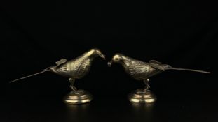 A pair of 19th century Indian repousse white metal Kutch silver figural birds raised on stepped