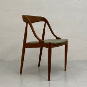 A mid-century Danish teak elbow dining chair having a curved back and arms over a slanted seat
