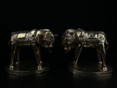 A pair of 19th century Indian repousse white metal Kutch silver sacred Kamdhenu cows with chased