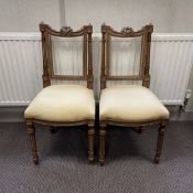 A pair of 19th century French walnut side chairs each having a curved top rail with a carved harp
