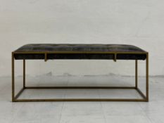 A vintage Hanbel bench model KN222 having a distressed leather buttoned seat set into a simple brass