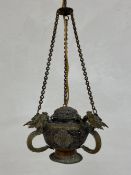 A C.1900 Tibetan brass mounted copper hanging incense burner having a lidded openwork urn shaped